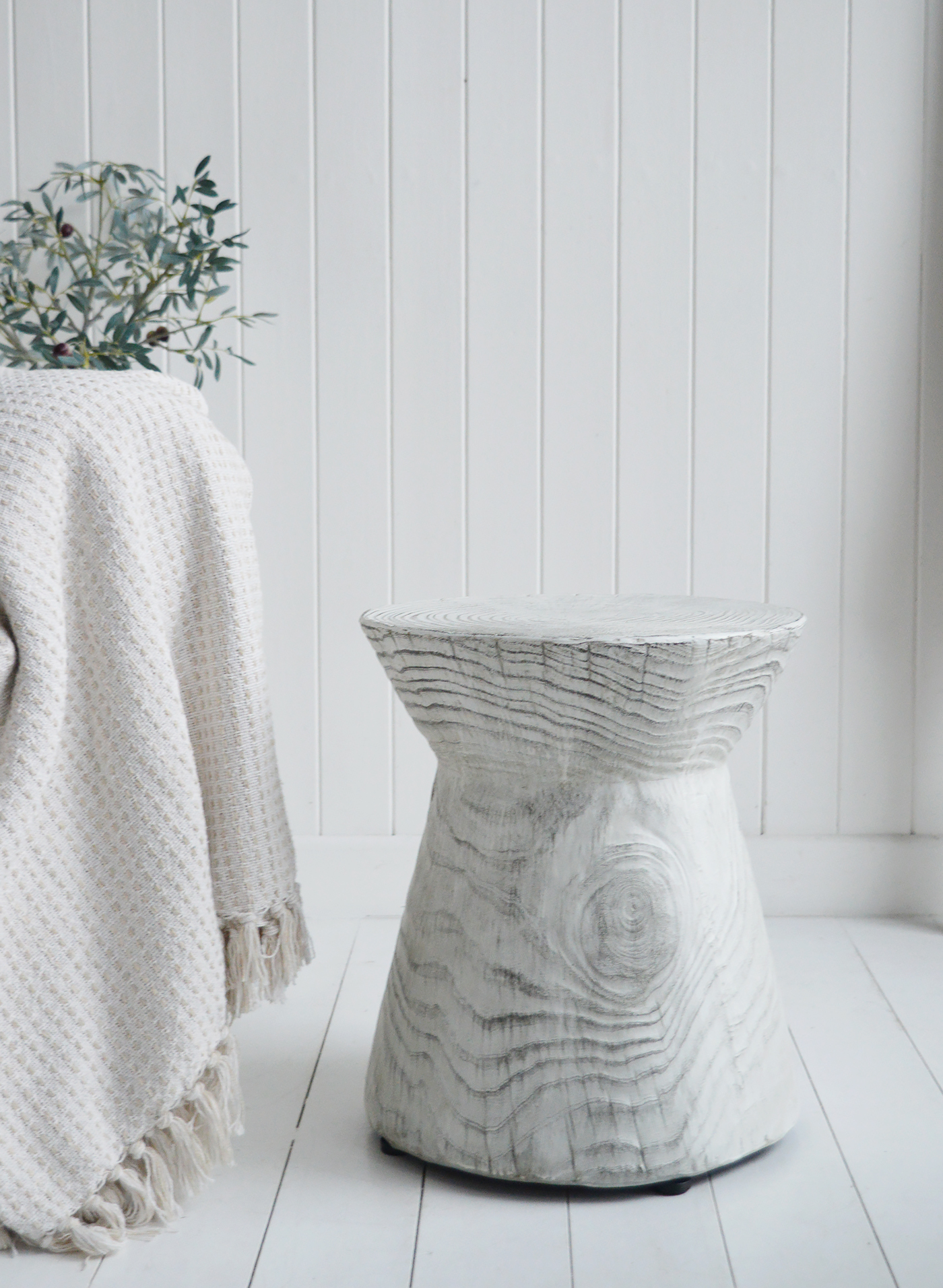 Its sculptural shape and weathered finish make it an elegant addition to modern coastal and beach house furniture.